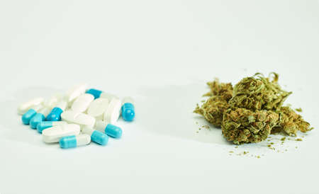 pharmacological pills, and pile of marijuana, white backgroundの写真素材