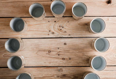 recycled cans, reused on a table with a brown background top view, space for text.の写真素材
