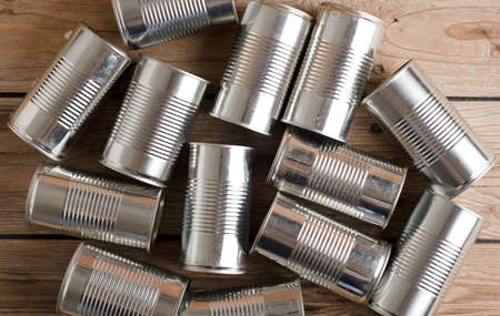 recycling of cans for home on rustic wooden table. second life to aluminum cansの写真素材