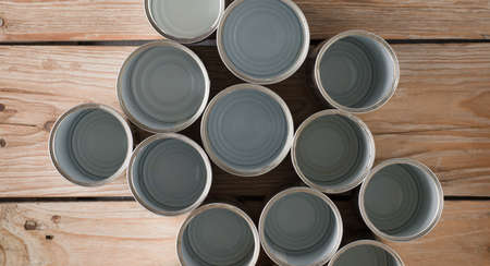 recycled cans, reused on a table with a brown background top view, space for text.の写真素材