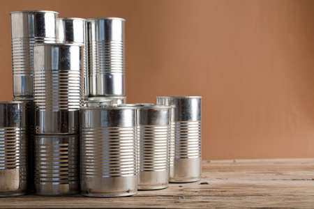 recycled cans, reused on a table with a brown backgroundの写真素材