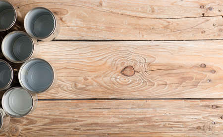 recycled cans, reused on a table with a brown background top view, space for text.の写真素材
