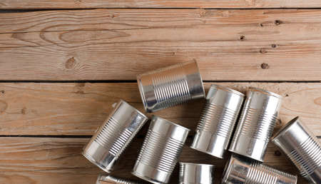 recycled cans, reused on a table with a brown background top view, space for text.の写真素材