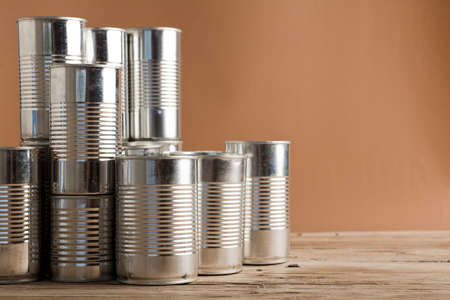 recycled cans, reused on a table with a brown backgroundの写真素材