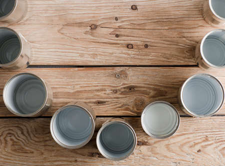 recycled aluminum cans, on old rustic woodの写真素材