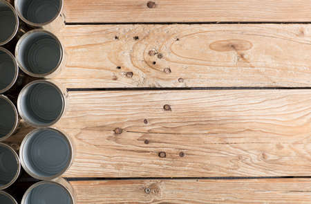 recycled cans, reused on a table with a wood brown backgroundの写真素材