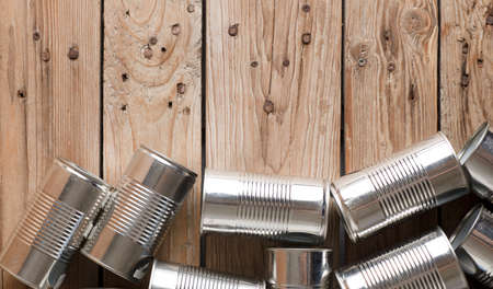 recycled cans, reused on a table with a wood brown backgroundの写真素材