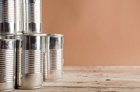 recycled cans, reused on a table with a brown backgroundの写真素材