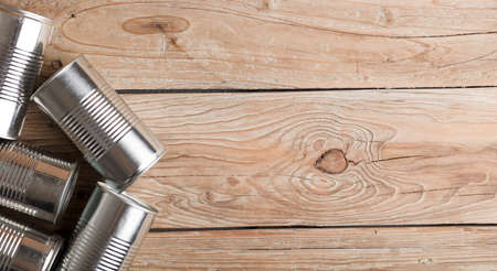 recycled cans, reused on a table with a wood brown backgroundの写真素材