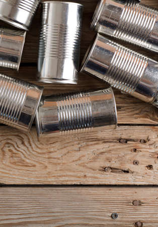 recycled cans, reused on a table with a wood brown backgroundの写真素材