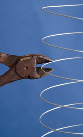 coiled metal wire cutting pliers, blue backgroundの写真素材