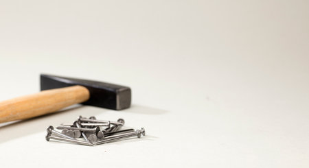 hammer nails on table, white backgroundの写真素材