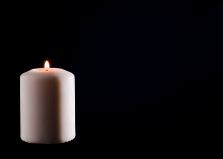 Wax candle with a dark back flameの写真素材