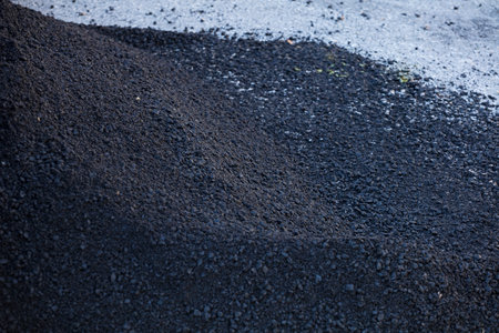 bluish-black granular asphalt on the ground outdoorsの写真素材