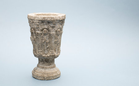 ancient stone chalice on isolated light gray backgroundの写真素材
