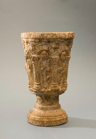 ancient stone chalice on isolated light gray backgroundの写真素材