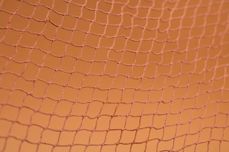 Brown fishing net, on soft brown background