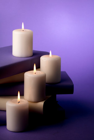 candles and books with purple backgroundの写真素材