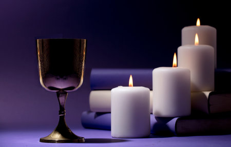 golden christian chalice with candles and purple backgroundの写真素材