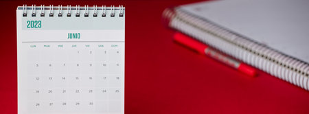 A calendar on a desk with the year 2023 June, red tableの写真素材