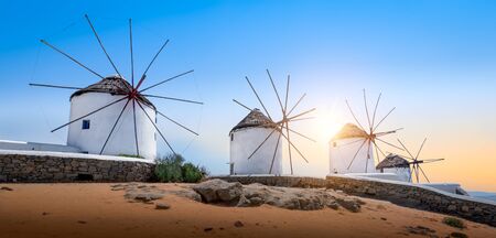 Mykonos, Greece. Famous white old windmills at sunset.の写真素材