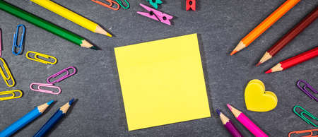 Back to school banner. School supplies on black board background.の写真素材