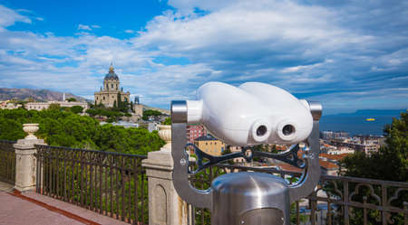 Public binoculars with a view of a beautiful church in Messina, Italy.の写真素材