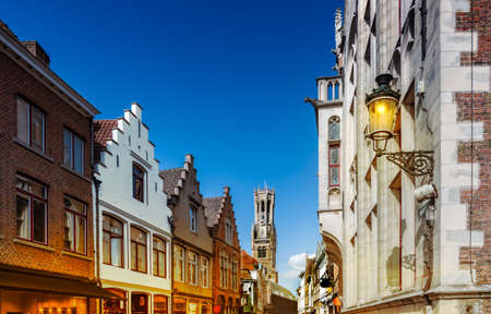Bruges, Belgium. Cityscape with traditional houses and medieval bell tower Belfry in the city center at dusk.の写真素材