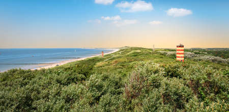 Panoramic coastal landscape with lighthouse in the dunes at the beautiful beach of Dishoek, Zeeland, The Netherlands.の写真素材