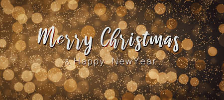 Golden brown blurred light pattern with handwritten Christmas and New Year wishes. Vintage style.の写真素材