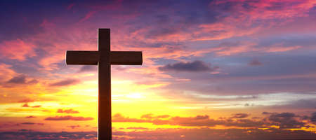 Silhouette of crucifix cross at sunset sky.の写真素材