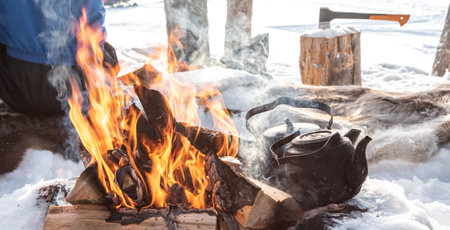 Campfire with kettle in the snow. Adventure in Finland.