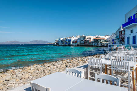 Mykonos, Greece. Tables and chairs by the waterfront in Little Venice, Mykonos Island.の写真素材