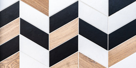 Abstract geometric pattern of different textures ceramic tiles with rhomboid shape in black and white colors and natural wood look.の写真素材