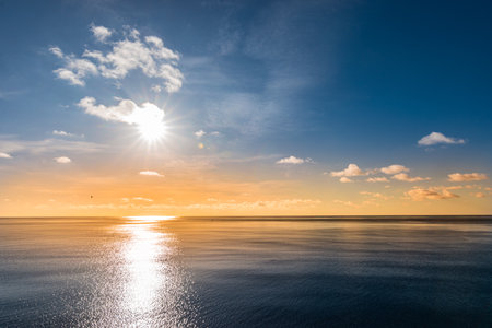 Beautiful colorful sunset sky with reflection of the sun in the Indian Ocean.の写真素材