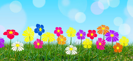 Colorful flowers on green grass with blue sky background.の写真素材