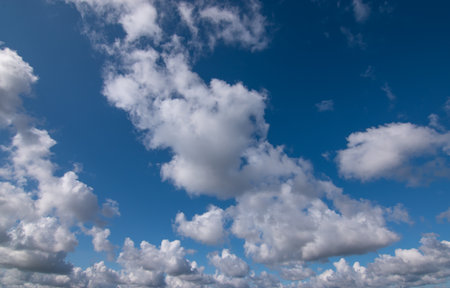 Blue sky background with white clouds. Cumulus white clouds in the blue sky.の写真素材