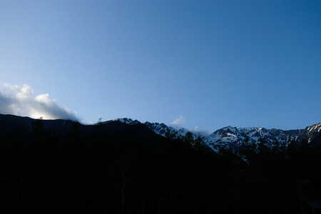 Sunset light and snow mountains view from Kamikochi Bus Station, Japanのeditorial素材