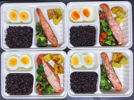 Salmon steak cleanfood box including tomatoes, broccoli, egges, tomatoes, and riceberry rice.