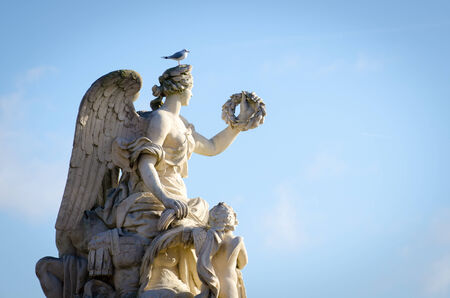Statue with a bird standing on topの写真素材