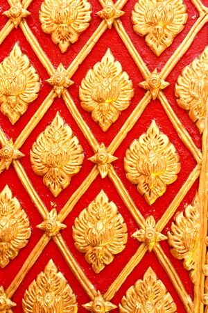 Golden Thai pattern design on temple wallの写真素材