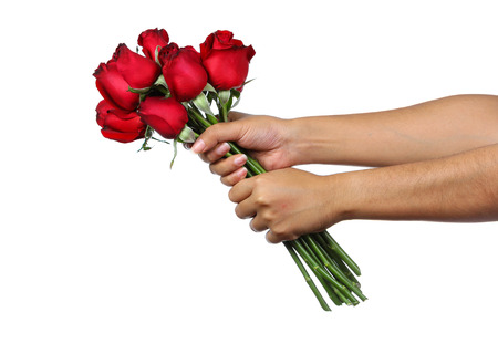 Hand holding bouquet of red roses isolate on whiteの写真素材