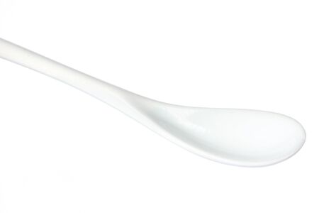 White plastic spoon isolated on whiteの写真素材