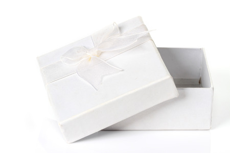 White gift box with white ribbon bow, isolated on white