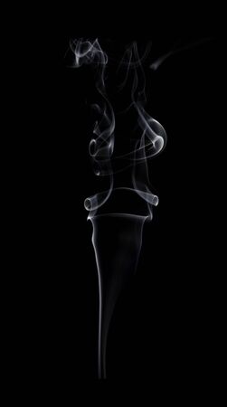 Abstract white smoke swirls on black background.の写真素材