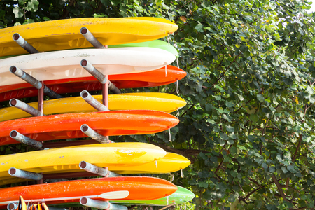 Colorful kayaks in stackの写真素材