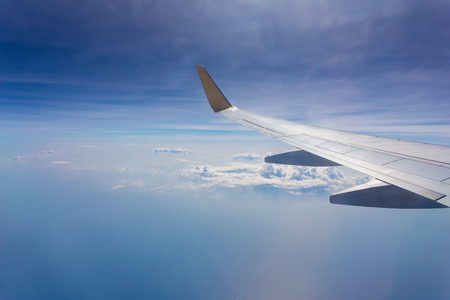 Aircraft wing on the clouds,flying backgroundの写真素材