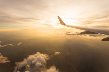 Aircraft wing on the clouds,flying backgroundの写真素材