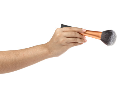 women hand with cosmetic brushes on white backgroundの写真素材