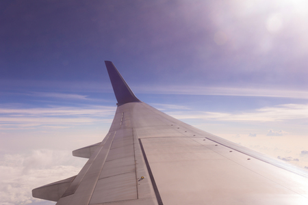 Aircraft wing on the clouds,flying backgroundの写真素材